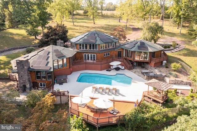 view of pool with a wooden deck and a patio