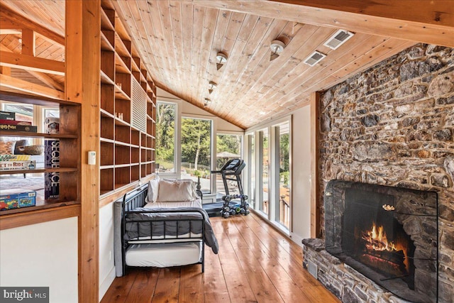 interior space with a fireplace, vaulted ceiling, hardwood / wood-style floors, and wooden ceiling