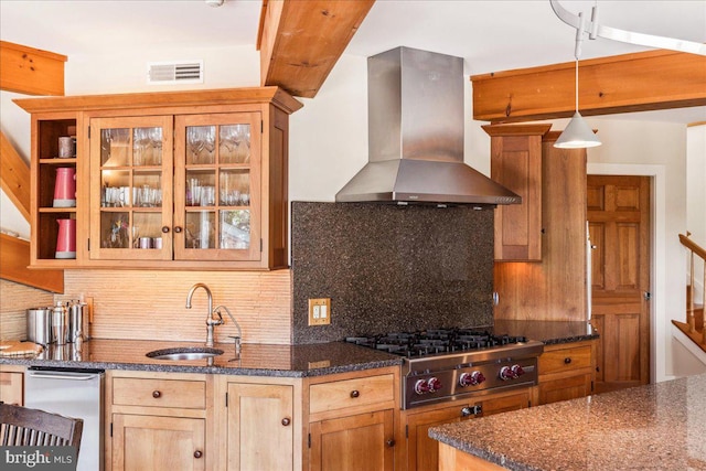 kitchen with wall chimney exhaust hood, appliances with stainless steel finishes, tasteful backsplash, hanging light fixtures, and sink