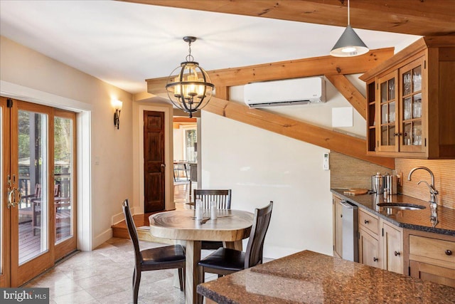 dining area featuring a wall mounted AC, an inviting chandelier, and sink