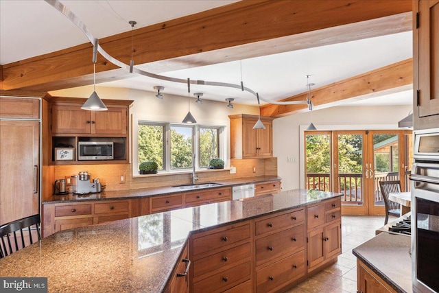 kitchen with pendant lighting, a healthy amount of sunlight, french doors, and decorative backsplash