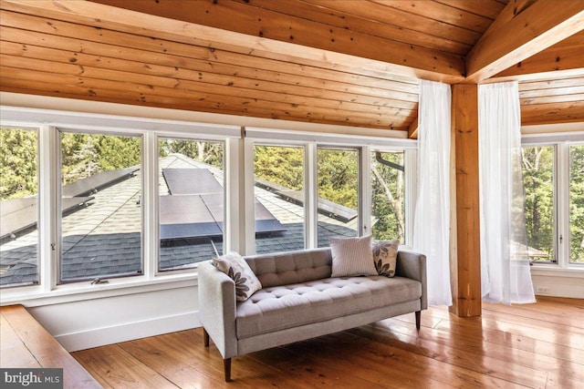 sunroom featuring vaulted ceiling and wood ceiling