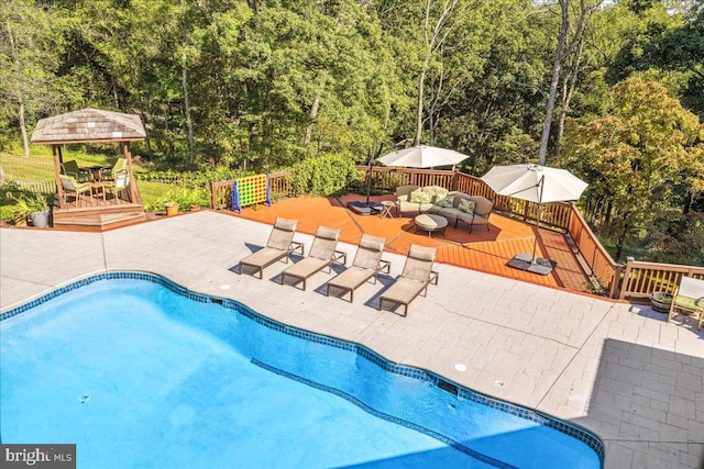 view of pool featuring an outdoor hangout area and a wooden deck