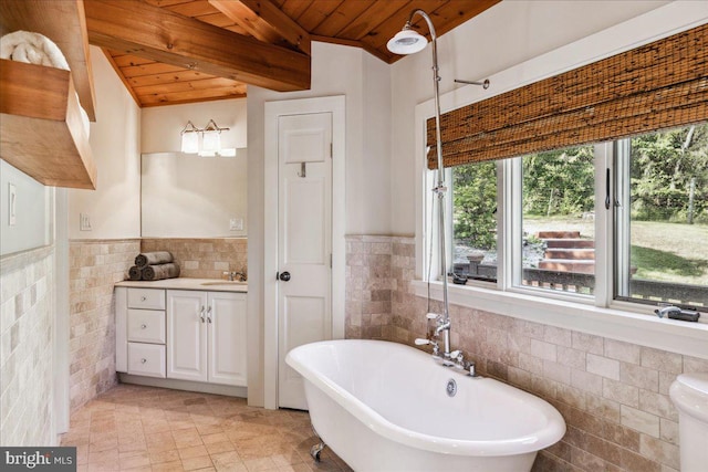 bathroom with beamed ceiling, vanity, tile walls, wooden ceiling, and a bath