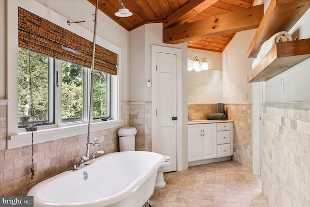 bathroom with vanity, a bathing tub, beamed ceiling, wooden ceiling, and tile walls