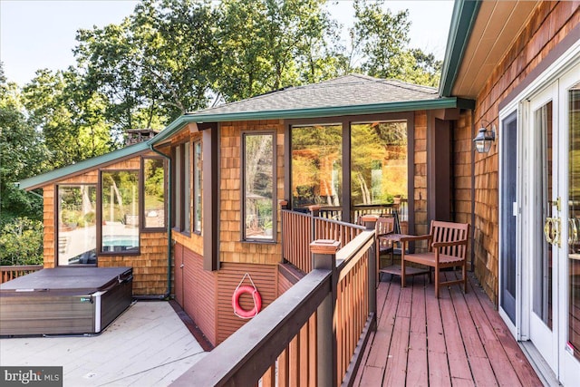 wooden deck featuring a hot tub