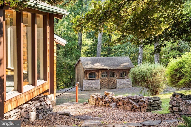 view of property exterior with an outdoor structure