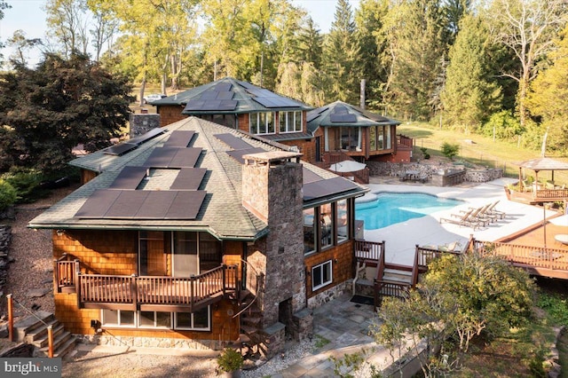 exterior space featuring a gazebo, a patio area, and a deck