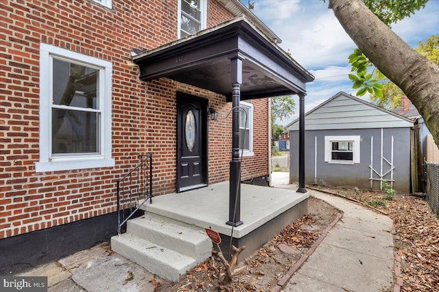 view of exterior entry featuring brick siding