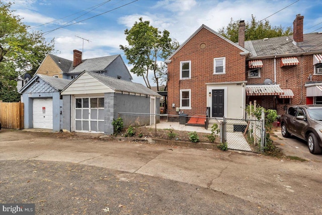 view of front facade featuring brick siding, a gate, and fence