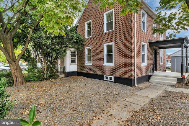 view of property exterior featuring brick siding