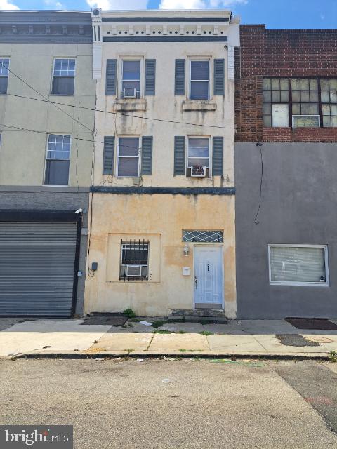 view of front of house with a garage and cooling unit