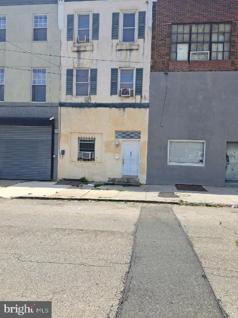 view of building exterior with cooling unit and a garage