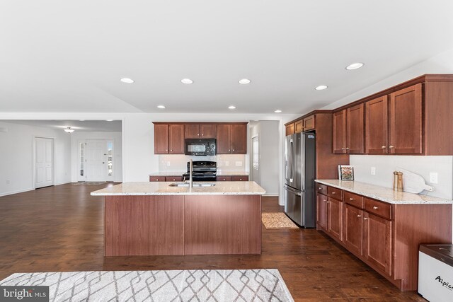 kitchen featuring black appliances, light stone counters, and dark hardwood / wood-style flooring