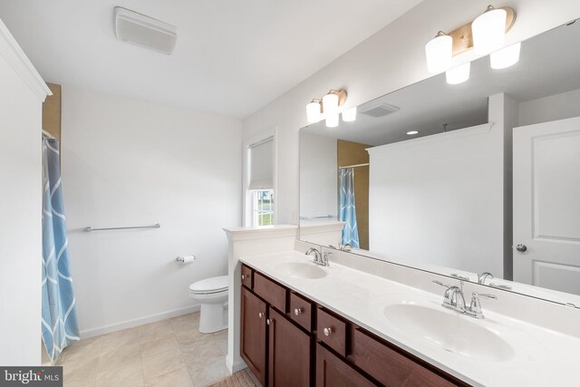 bathroom with tile patterned flooring, vanity, toilet, and a shower with shower curtain