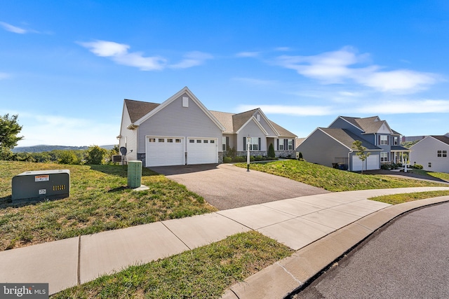 view of front of property featuring a front yard and a garage