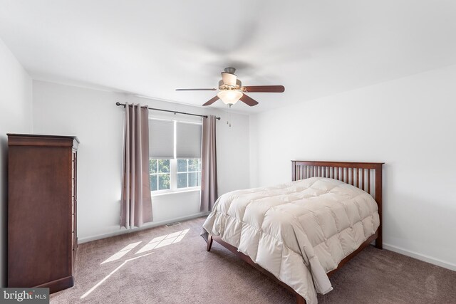 bedroom featuring ceiling fan and light carpet