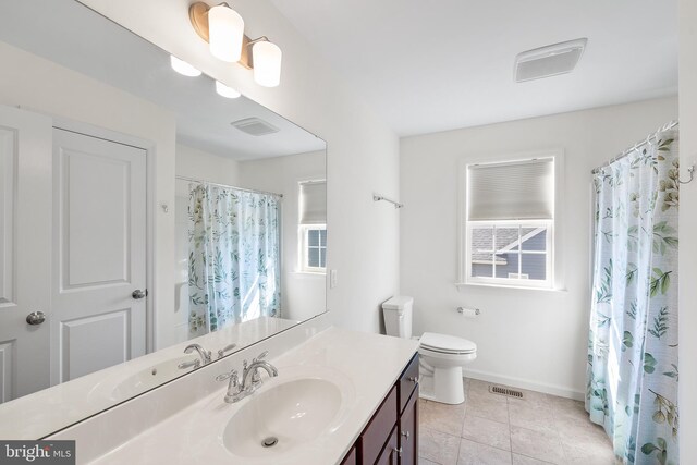 bathroom with tile patterned floors, walk in shower, toilet, and vanity