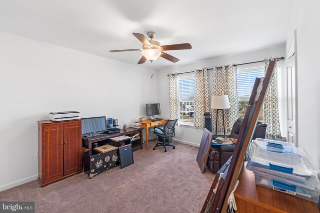 office area with ceiling fan and light carpet