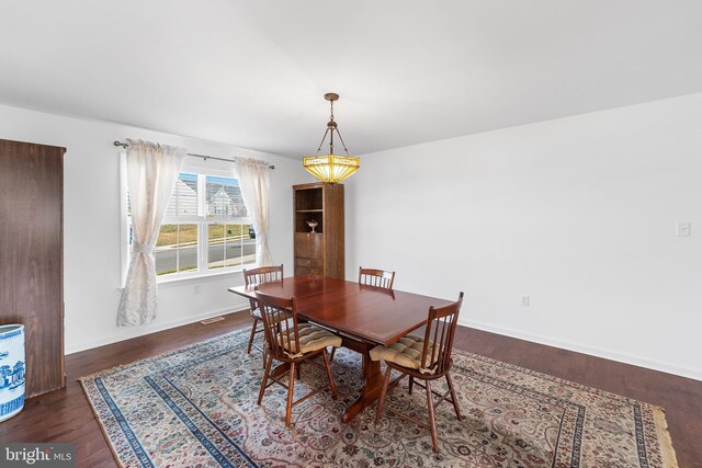 dining space with dark hardwood / wood-style floors