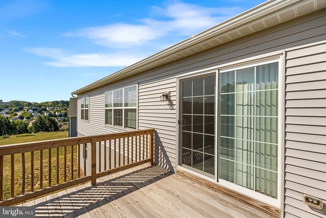 wooden deck with a lawn