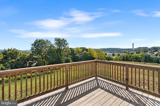 wooden deck featuring a yard