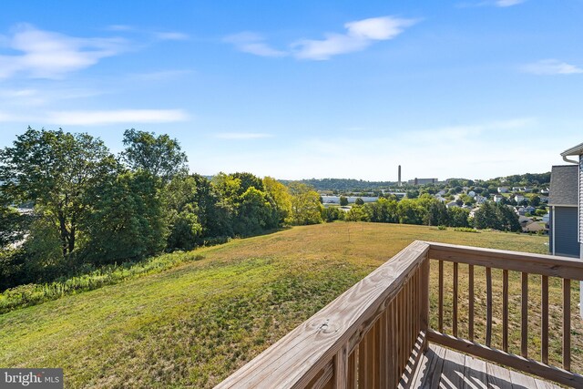 wooden deck with a lawn