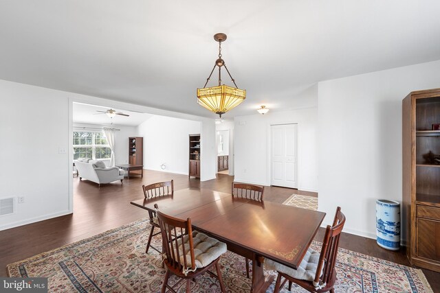 dining area with ceiling fan and dark hardwood / wood-style floors