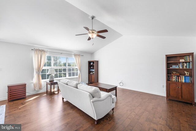 living room featuring dark wood-type flooring, ceiling fan, and vaulted ceiling