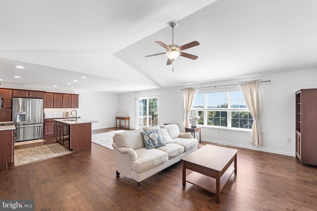 living room with vaulted ceiling, ceiling fan, dark hardwood / wood-style flooring, and sink