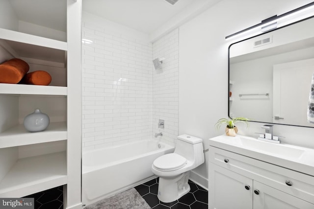 full bathroom featuring tile patterned flooring, tiled shower / bath, toilet, and vanity