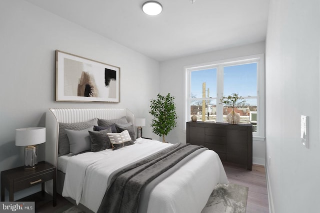 bedroom with hardwood / wood-style flooring