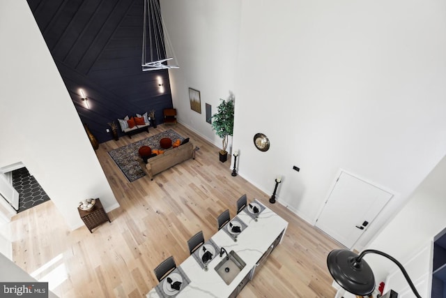 unfurnished living room featuring light hardwood / wood-style flooring and a high ceiling