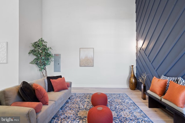 living room featuring electric panel and light hardwood / wood-style floors