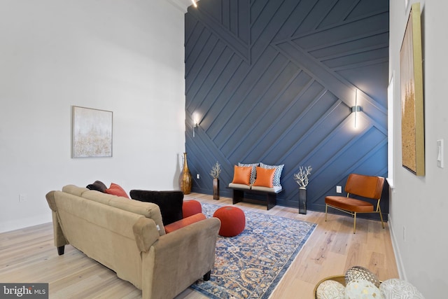 living room featuring wood walls and light hardwood / wood-style floors