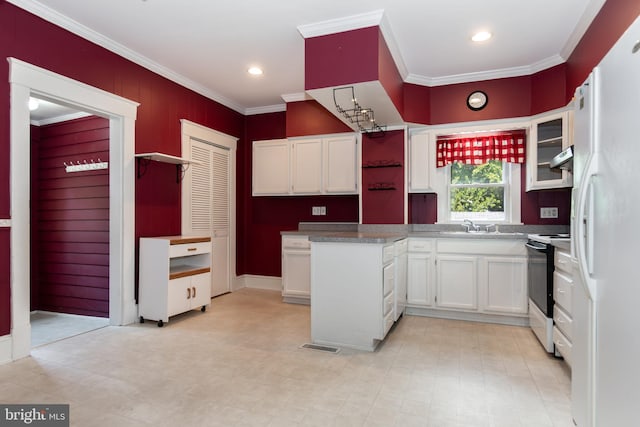 kitchen featuring range with electric cooktop, white cabinets, freestanding refrigerator, and crown molding