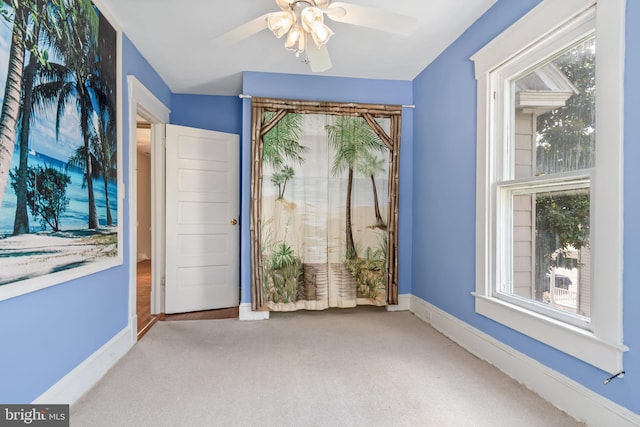 unfurnished room with ceiling fan and carpet floors