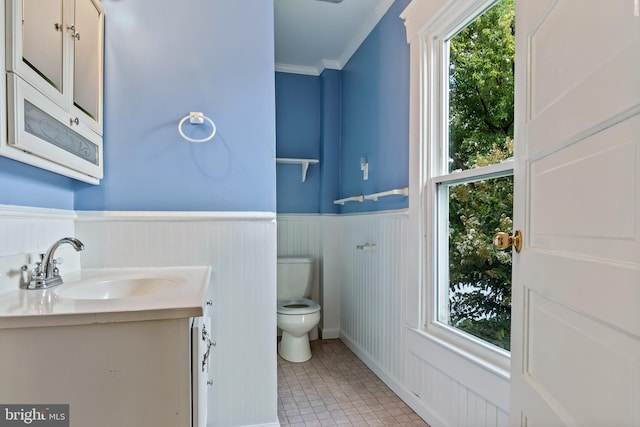 bathroom featuring crown molding, vanity, toilet, and tile patterned floors