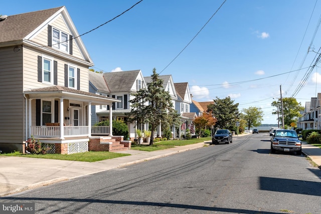 view of road featuring a residential view, curbs, and sidewalks