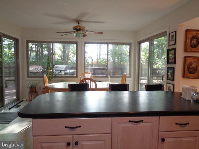 kitchen with white cabinets and ceiling fan