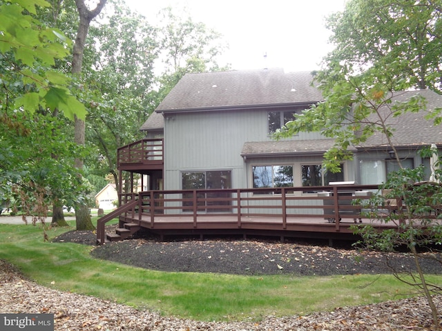 rear view of house featuring a deck