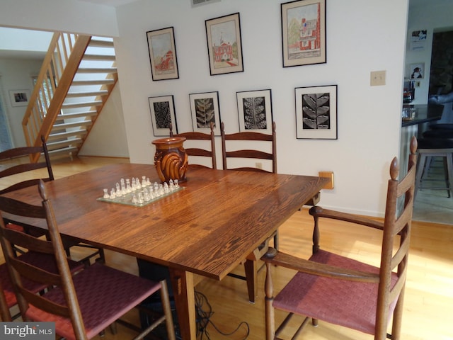 dining space with light wood-type flooring