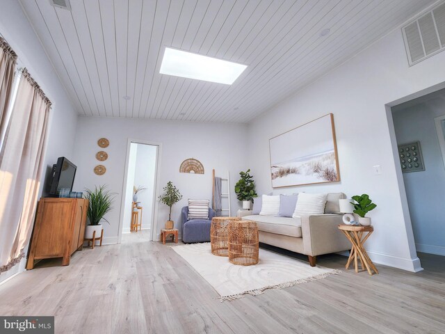 interior space with hardwood / wood-style flooring, lofted ceiling with skylight, and wooden ceiling