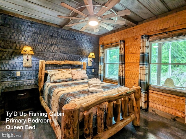 bedroom with ceiling fan, hardwood / wood-style flooring, multiple windows, and wood walls