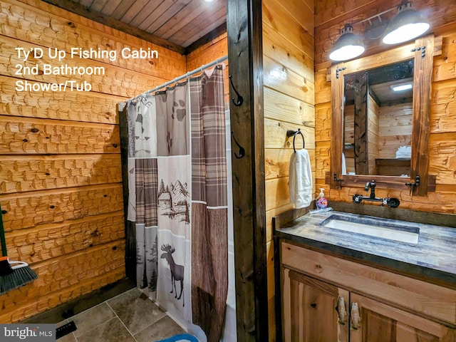 bathroom featuring vanity, tile patterned floors, wood ceiling, and wood walls