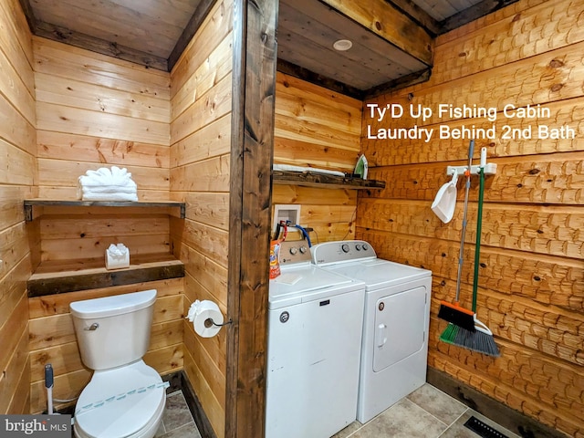 laundry room featuring wood walls, light tile patterned floors, separate washer and dryer, and wooden ceiling