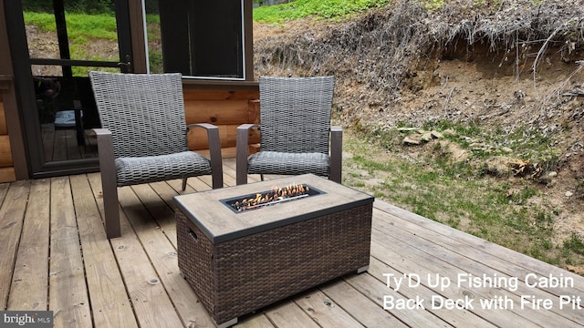 wooden deck with an outdoor fire pit