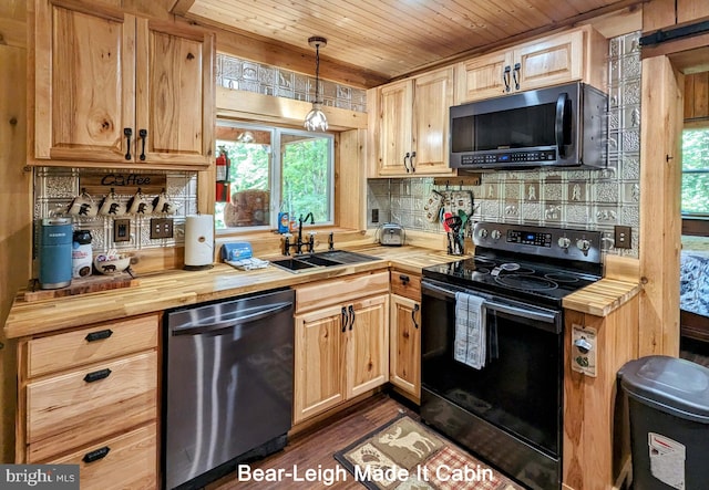 kitchen with butcher block counters, wooden ceiling, sink, black appliances, and decorative light fixtures