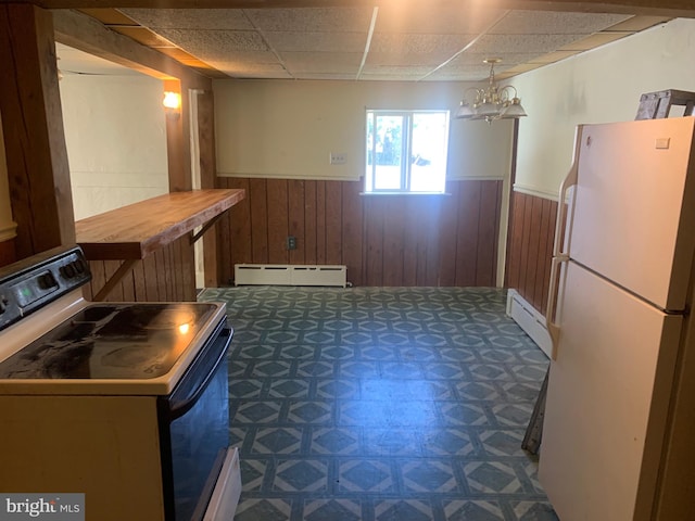 kitchen featuring a paneled ceiling, baseboard heating, range with electric cooktop, and white fridge