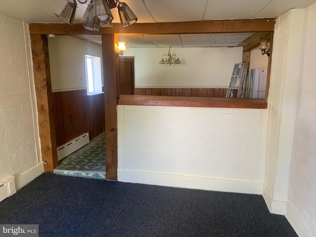 bar with a baseboard heating unit, carpet flooring, a wainscoted wall, and wood walls